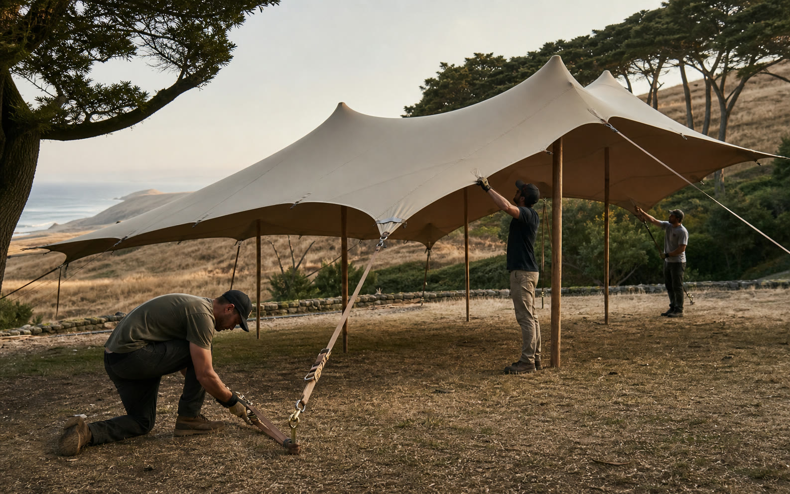 Professional crew safely installing and tensioning a stretch tent in California
