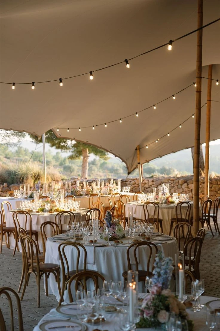 Wedding tables beneath a stretch canopy