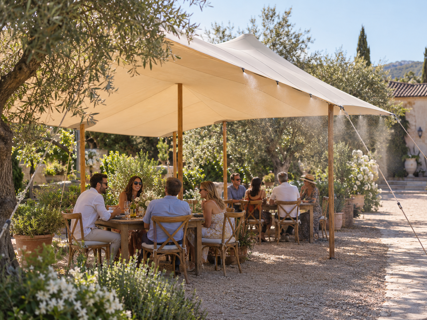 Guests enjoying shade with optional mist cooling beneath a stretch tent
