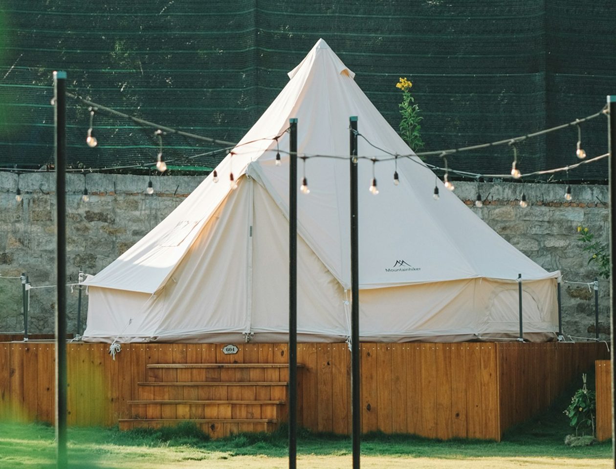Premium stretch tent canopy covering a green field venue for a festival event